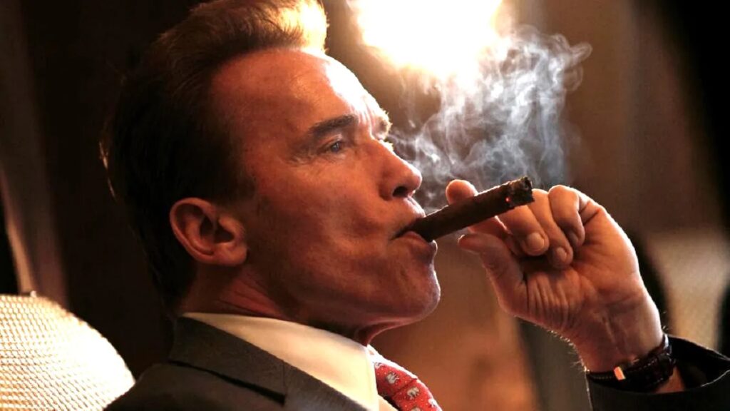 arnold schwarzenegger smokers a cigar